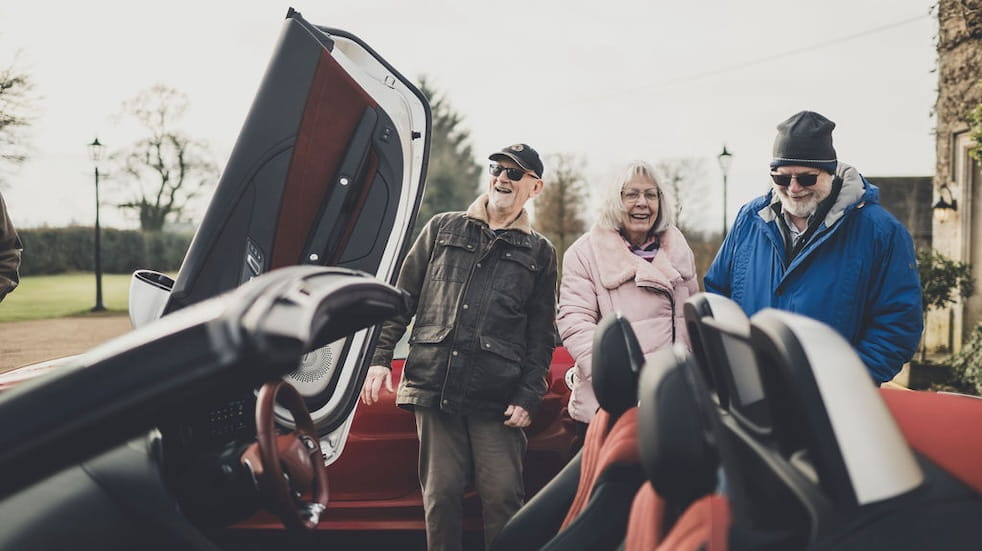 Group of vintage MG owners looking at the MG Cyberster